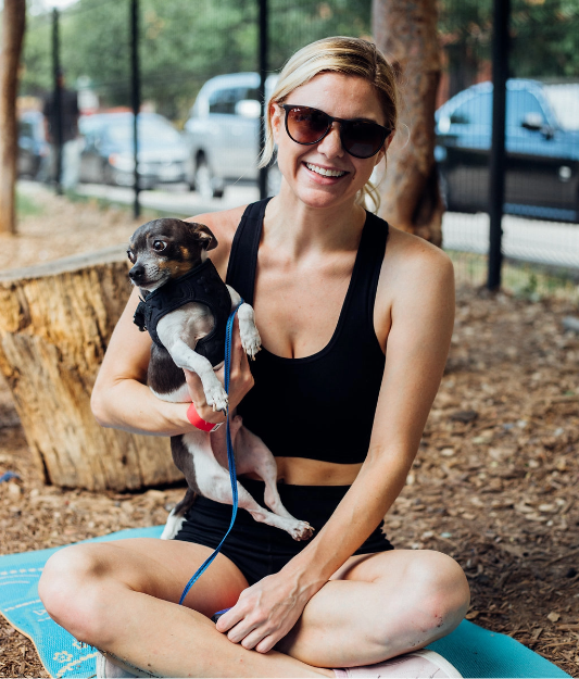 blonde wman holding lap dog smiling